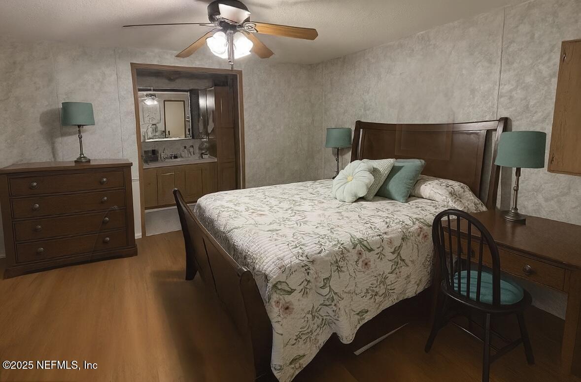 86266 Weldon Road Yulee, FL 32097 - Photo 4 of 10 a bedroom with a bed and a chandelier