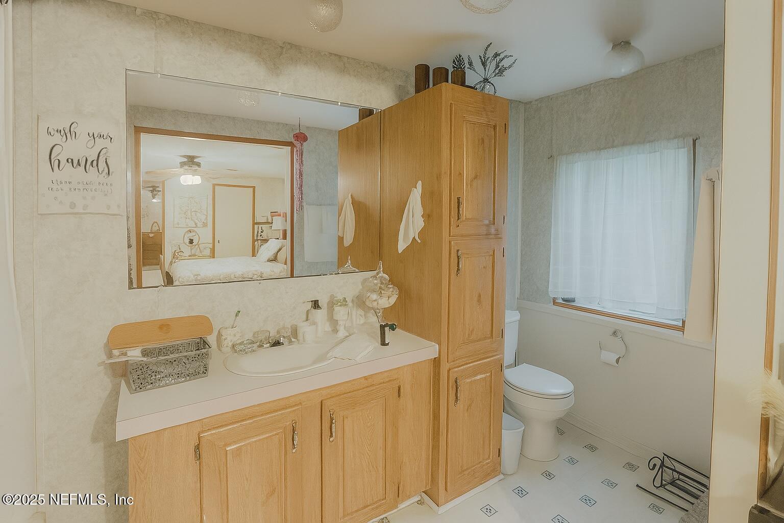 86266 Weldon Road Yulee, FL 32097 - Photo 5 of 10 a bathroom with a sink and a mirror