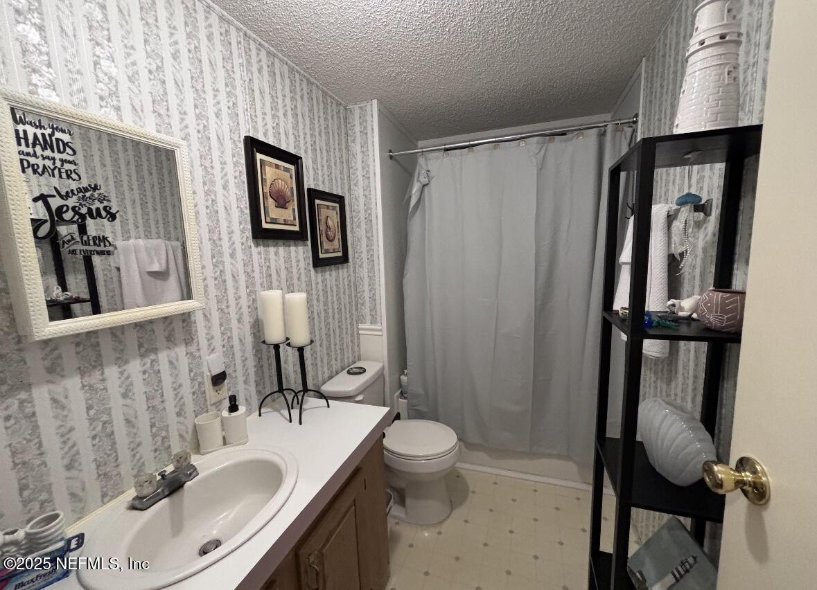 86266 Weldon Road Yulee, FL 32097 - Photo 7 of 10 a bathroom with a sink toilet and shower