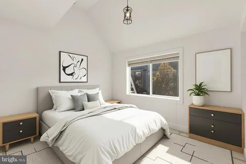a bedroom with a large bed and a window