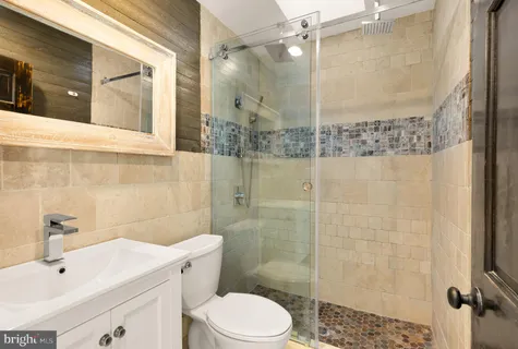 a bathroom with a toilet sink and shower