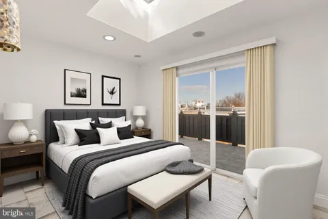 a bedroom with a bed and glass window