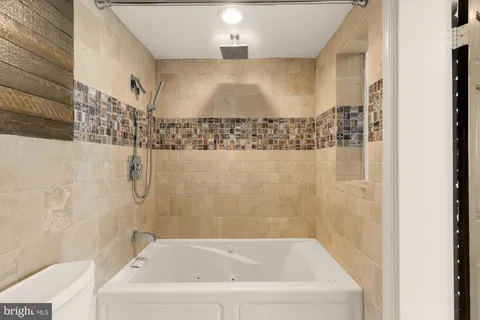 a bathroom with a bathtub and shower