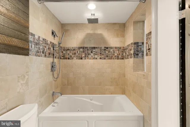 a bathroom with a bathtub and shower