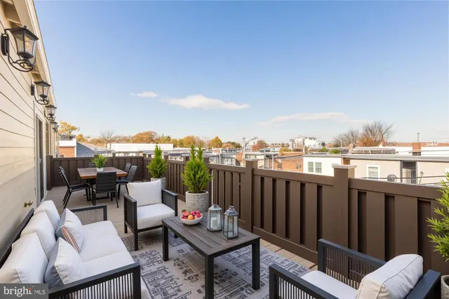 a view of a chairs and table in the balcony