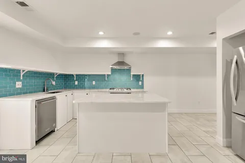 a kitchen with a washer and dryer