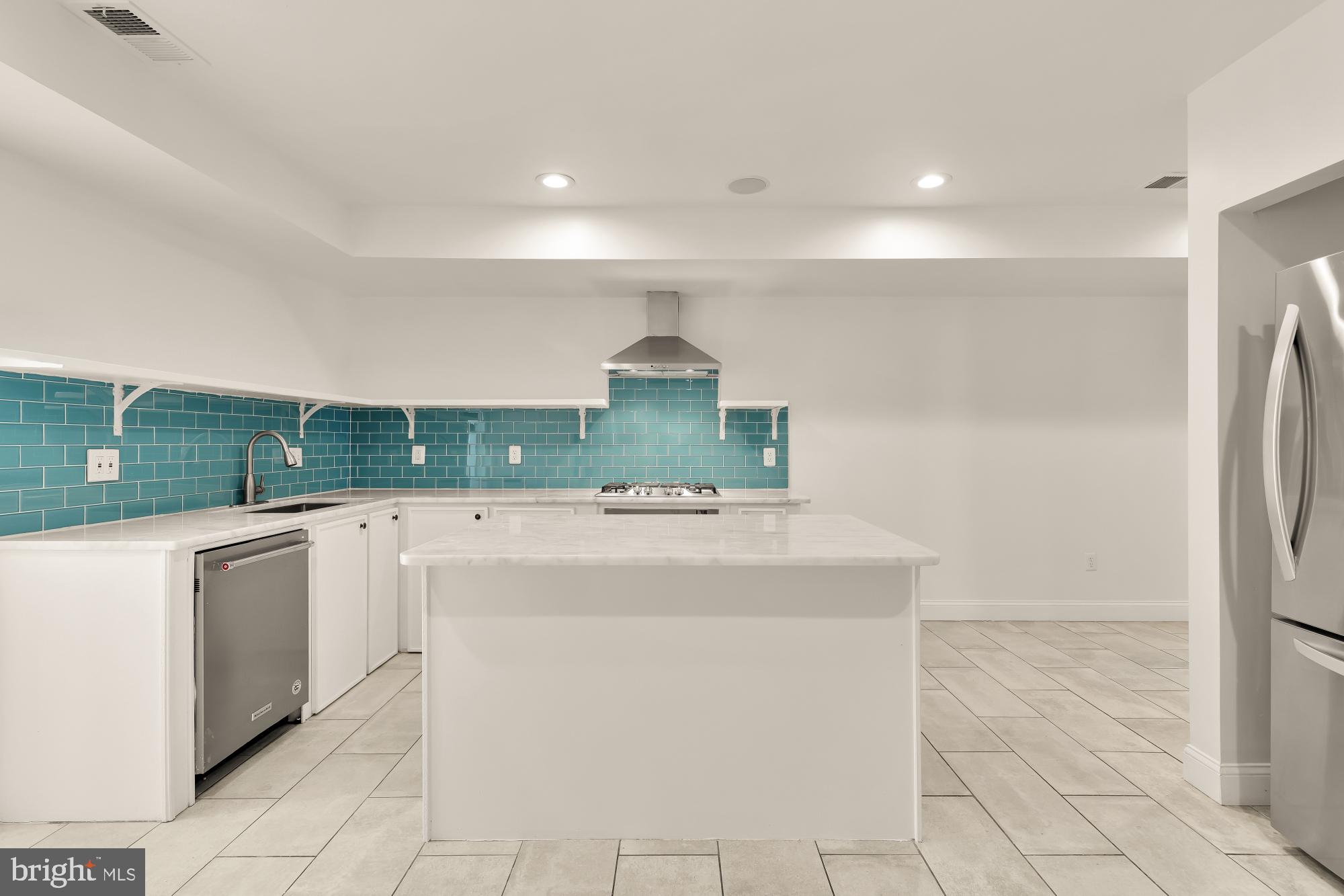 1210 Meigs Place Northeast Washington, DC 20002 - Photo 27 of 41 a kitchen with stainless steel appliances granite countertop a sink and a refrigerator