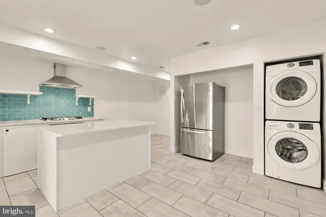 a kitchen with a sink and a stove top oven with granite countertops