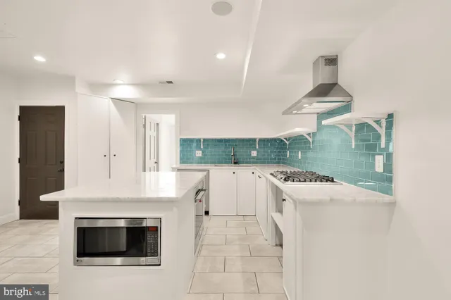 a kitchen with a stove a sink and a refrigerator