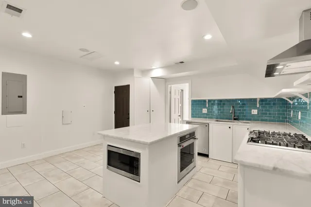 a kitchen with a sink and cabinets