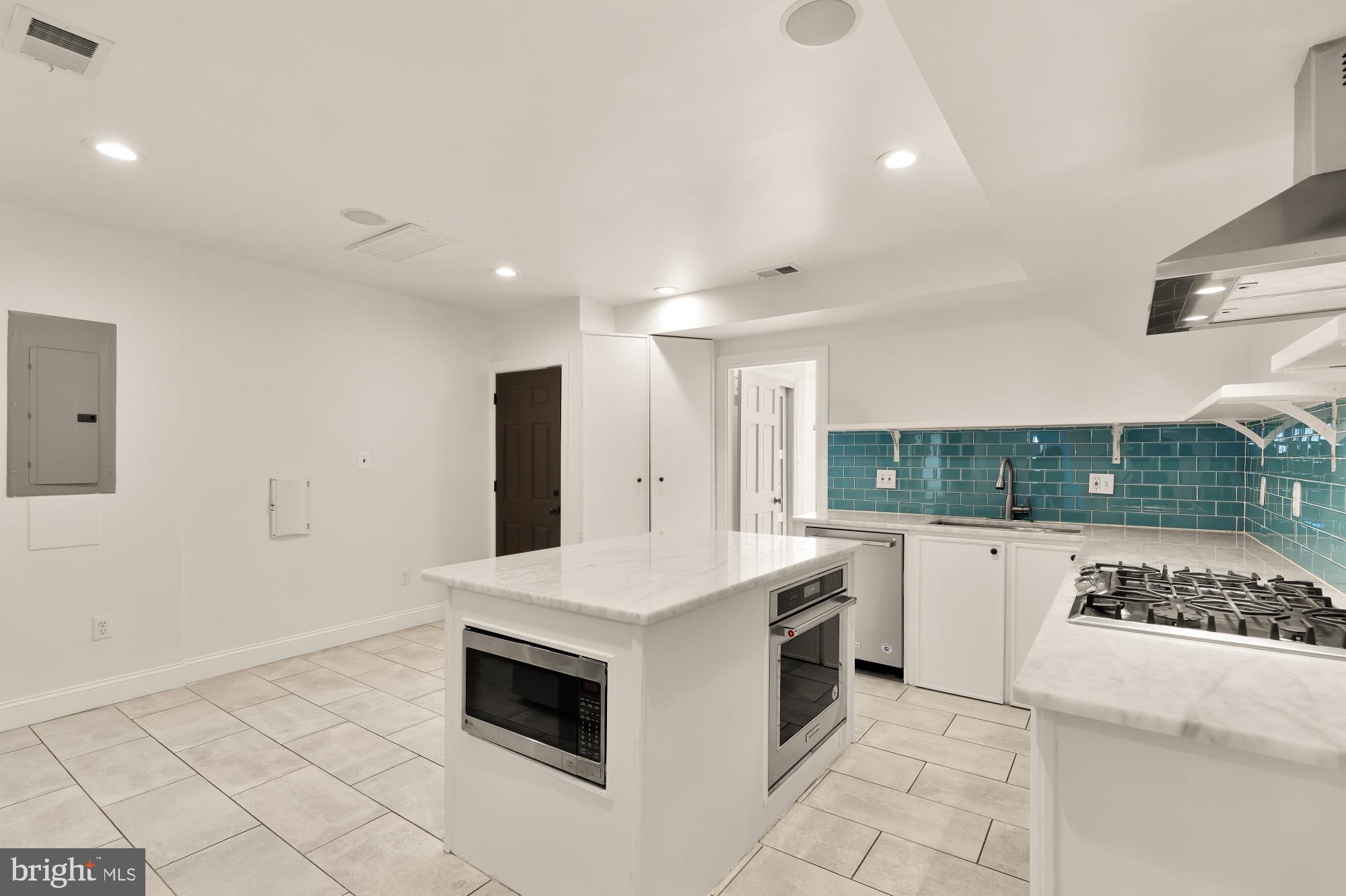1210 Meigs Place Northeast Washington, DC 20002 - Photo 30 of 41 a kitchen with a stove a sink and a refrigerator