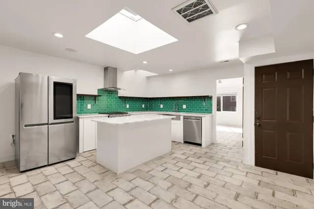 a view of kitchen with refrigerator and microwave