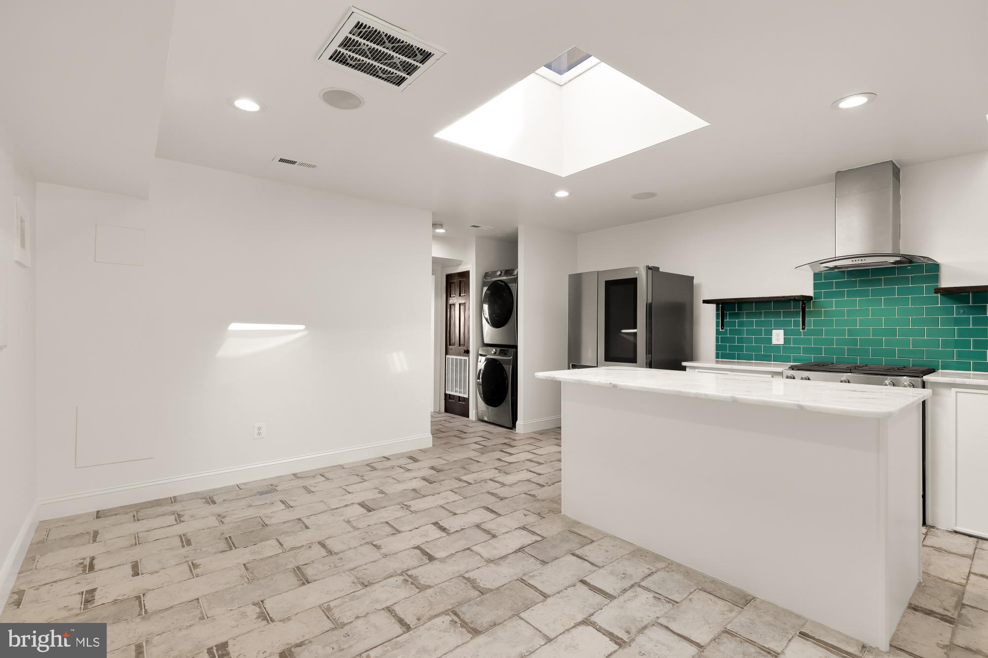 1210 Meigs Place Northeast Washington, DC 20002 - Photo 5 of 41 a living room with stainless steel appliances furniture a rug and a kitchen view