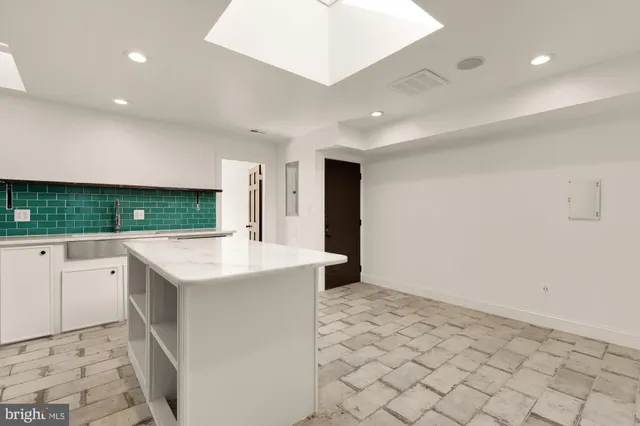 a kitchen with a sink cabinets and utility room