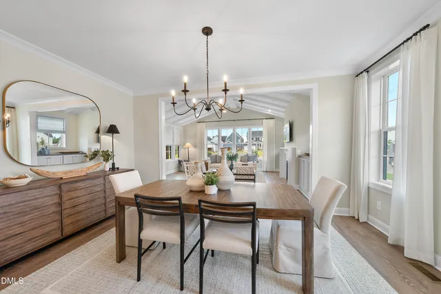 a view of a dining room with furniture wooden floor and chandelier