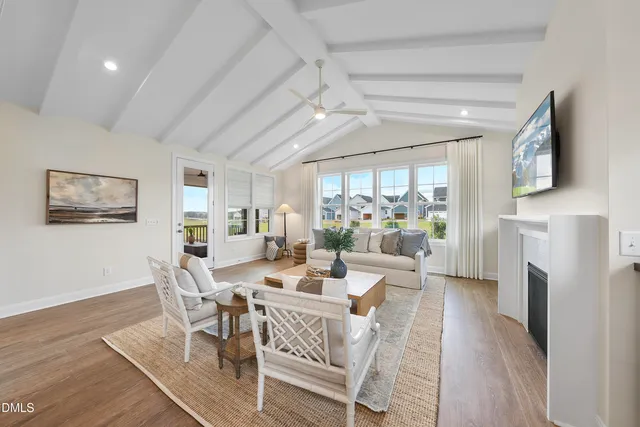 a dining room with furniture a fireplace and wooden floor