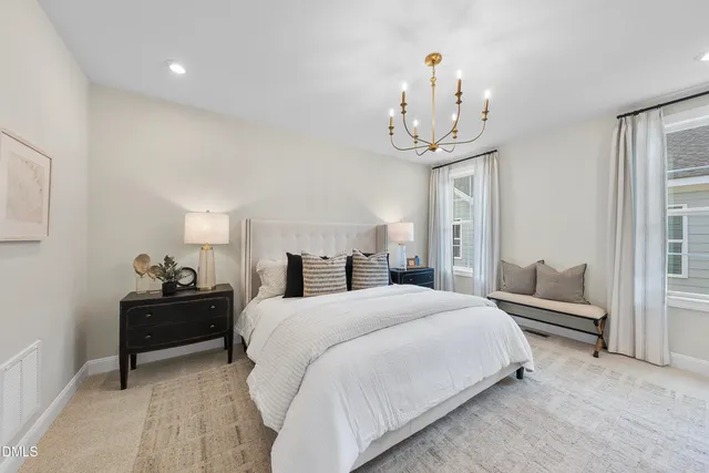 a bedroom with a bed and a chandelier