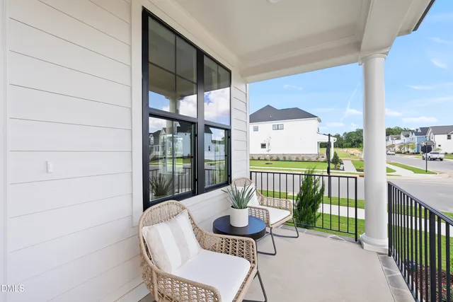a view of a balcony with chair and wooden floor