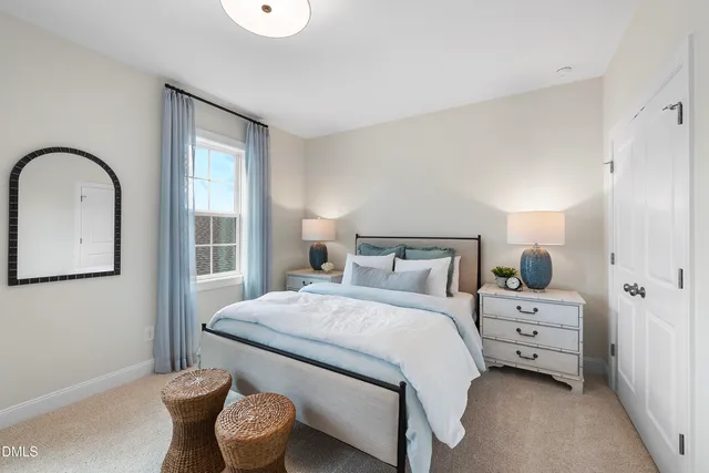 a bedroom with a bed and a large window