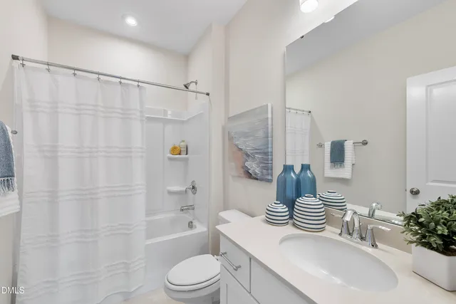 a bathroom with a sink toilet a shower curtain and a bath tub