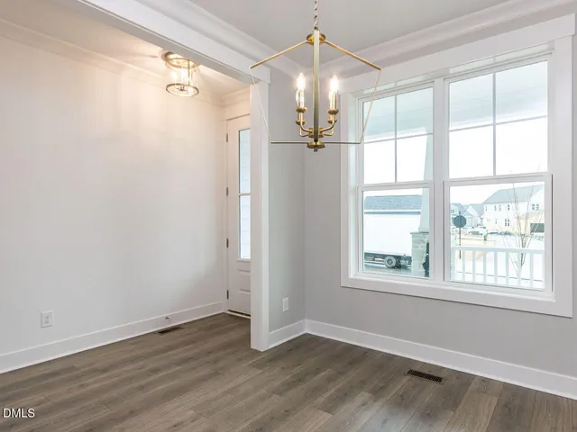 a view of staircase with white walls and a window