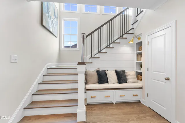 a view of entryway and hall with wooden floor