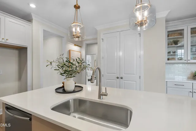 a front view of a kitchen center island and stainless steel appliances
