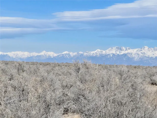 a view of a large mountain with mountains in the background