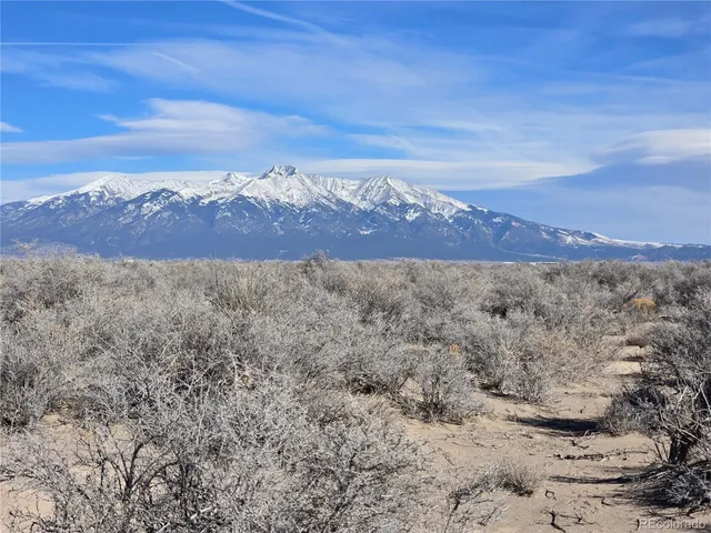a view of mountain with sunset in background