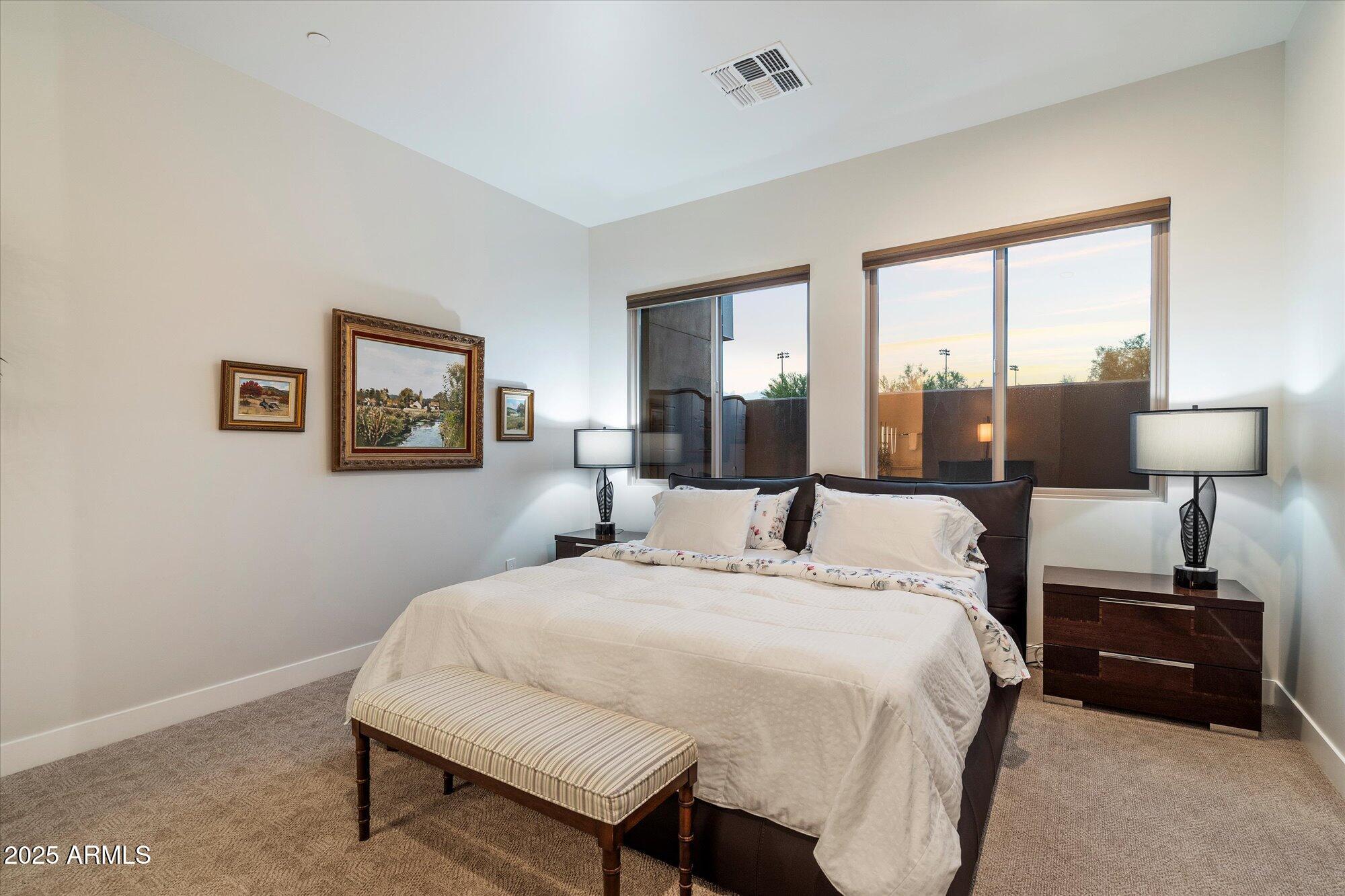 9850 East McDowell Mountain Ranch Road, Unit 1019 Scottsdale, AZ 85260 - Photo 26 of 66 a bedroom with a bed and wooden floor