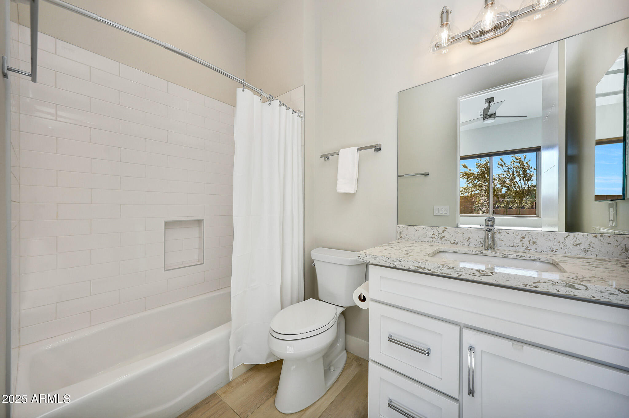 9850 East McDowell Mountain Ranch Road, Unit 1019 Scottsdale, AZ 85260 - Photo 40 of 66 a bathroom with a granite countertop sink toilet a mirror a bathtub and shower