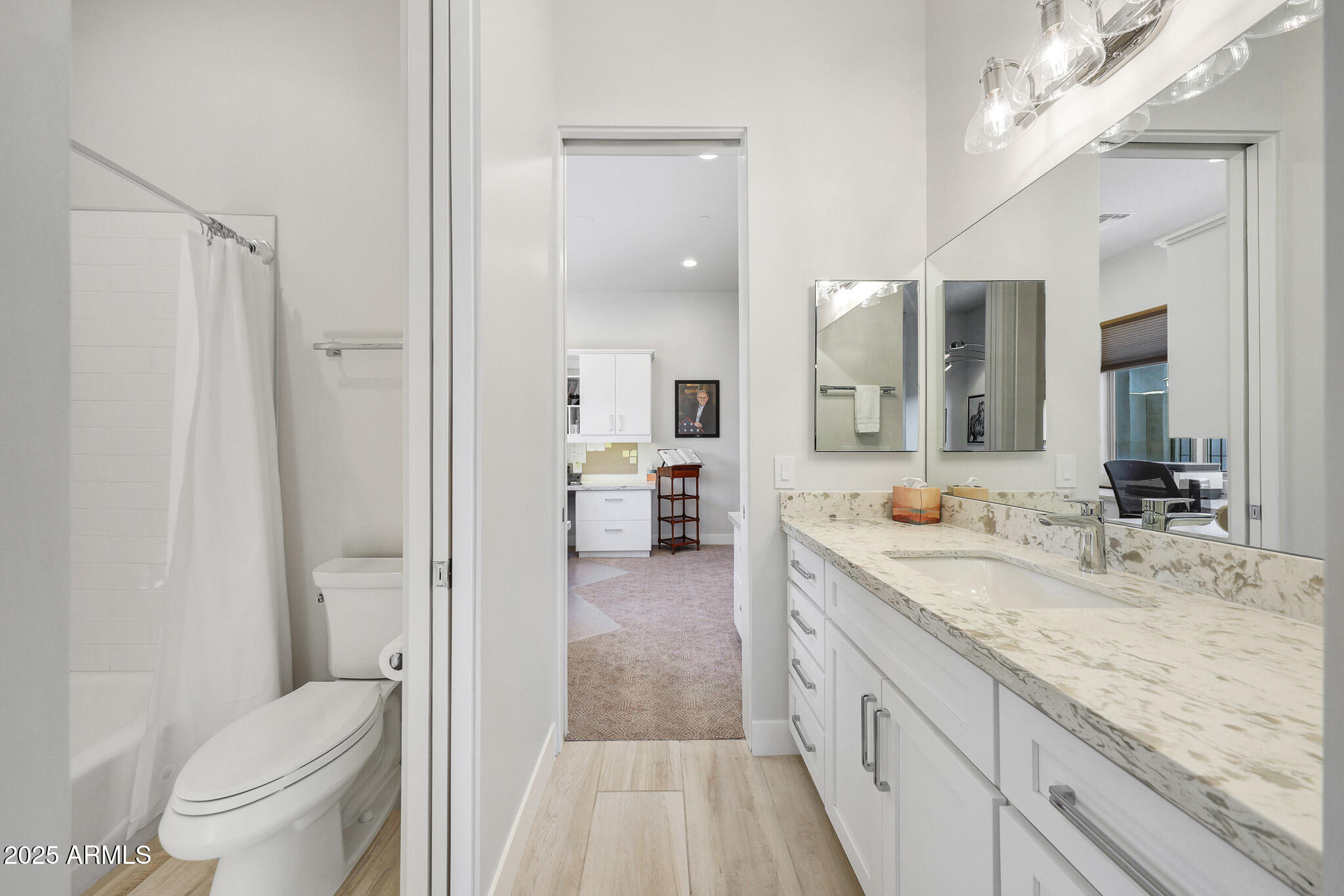 9850 East McDowell Mountain Ranch Road, Unit 1019 Scottsdale, AZ 85260 - Photo 43 of 66 a spacious bathroom with a granite countertop sink mirror and a toilet