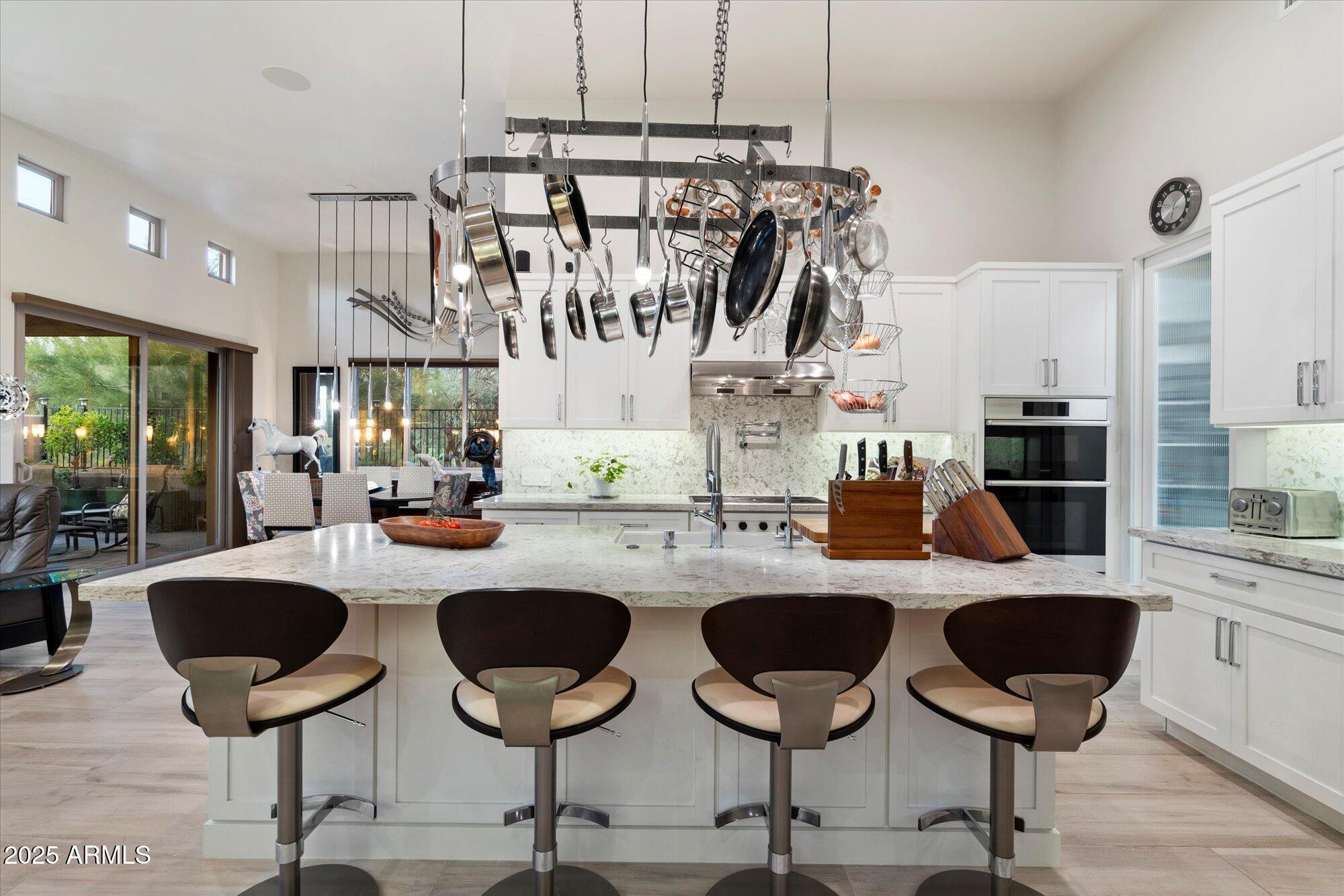 9850 East McDowell Mountain Ranch Road, Unit 1019 Scottsdale, AZ 85260 - Photo 6 of 66 a kitchen with lots of counter space furniture and a chandelier