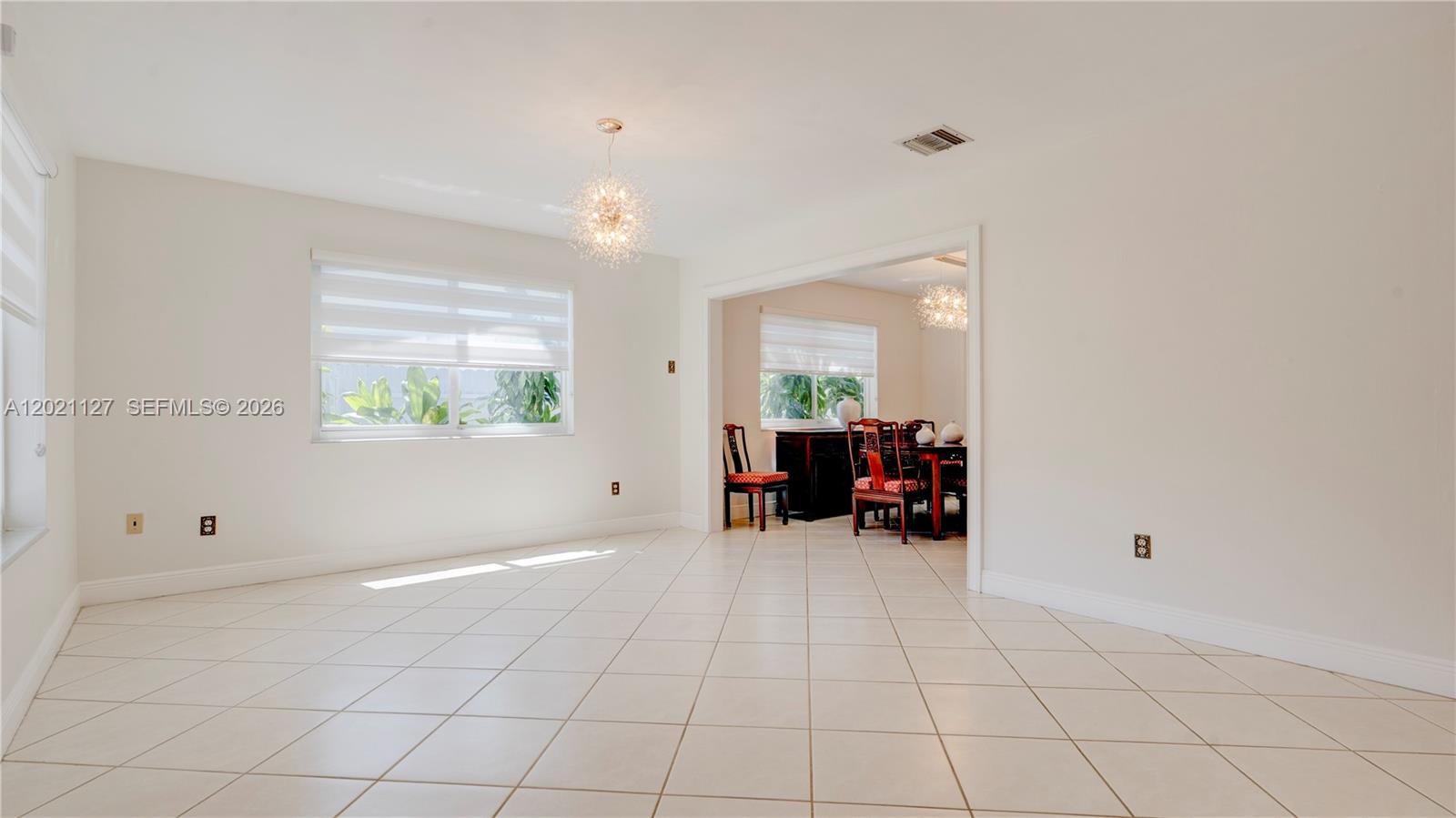 3611 Southwest 23rd Street Miami, FL 33145 - Photo 7 of 56 3613. This is the back 3/2 unit. The House is filled with natural light and lots of windows and doors with modern light fixtures and window treatments. This is the view from entryway to Living room and partial Dining Room