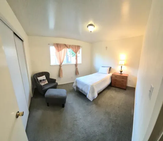 a bedroom with bed and a couch