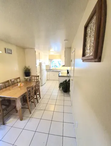 a view of a dining hall with furniture and a large window