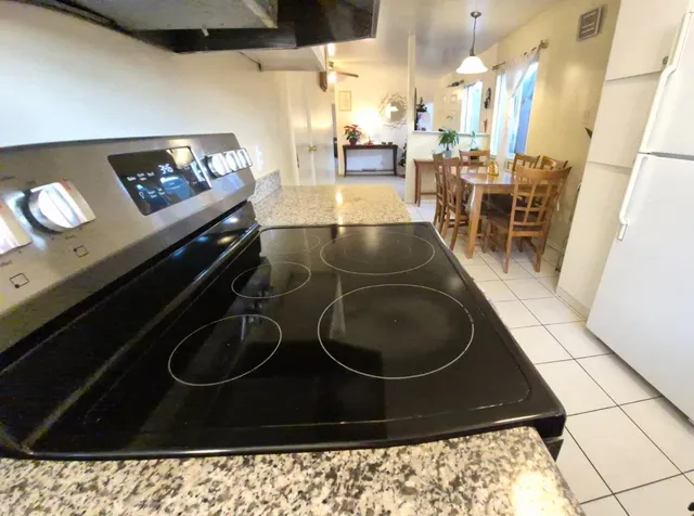 a living room with chairs and a rug