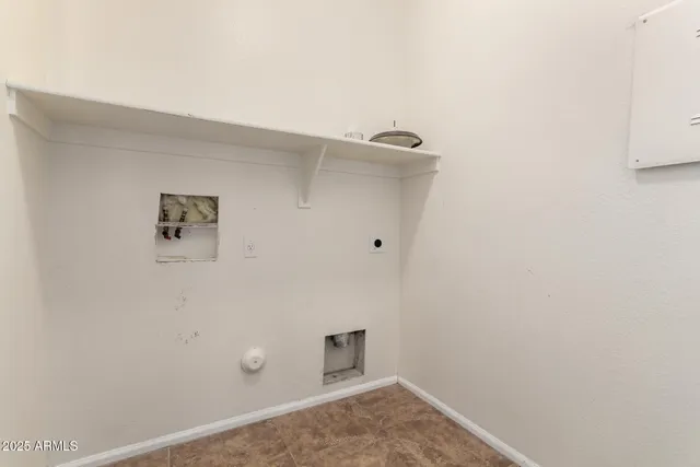 a view of a porch with a floor to ceiling window and potted plants
