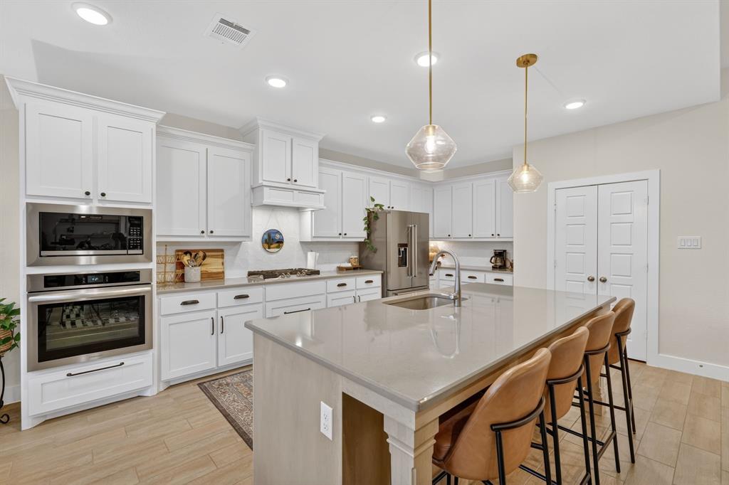 7117 Mantle Ridge Drive Fort Worth, TX 76179 - Photo 11 of 38 a kitchen with a stove a sink and a refrigerator