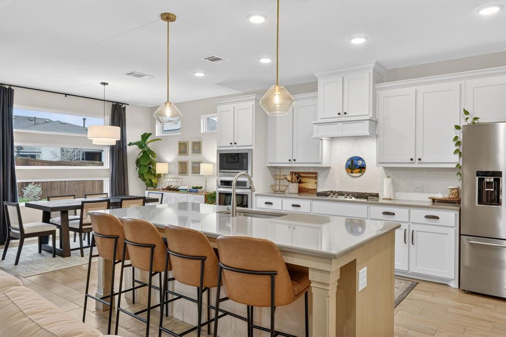 7117 Mantle Ridge Drive Fort Worth, TX 76179 - Photo 12 of 38 a kitchen with appliances a stove a table and chairs in it