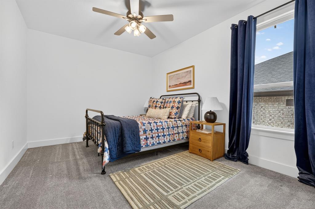 7117 Mantle Ridge Drive Fort Worth, TX 76179 - Photo 22 of 38 a bedroom with a bed and wooden floor