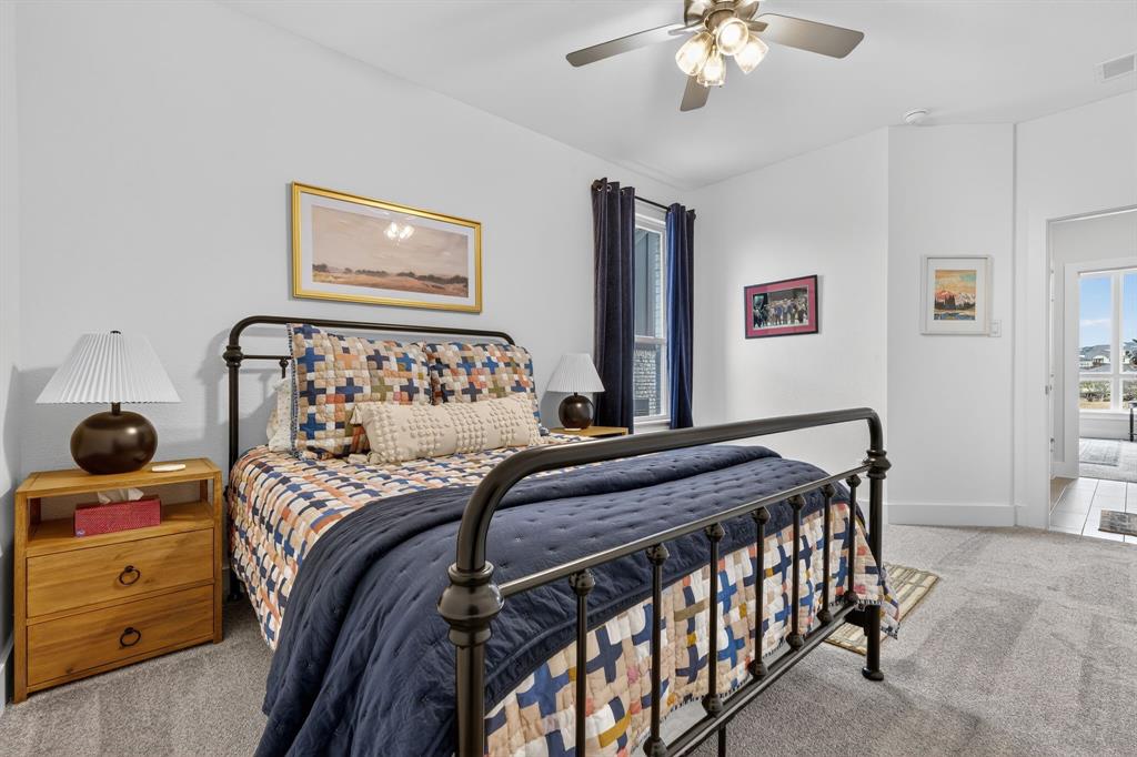 7117 Mantle Ridge Drive Fort Worth, TX 76179 - Photo 23 of 38 a bedroom with a bed and a chandelier