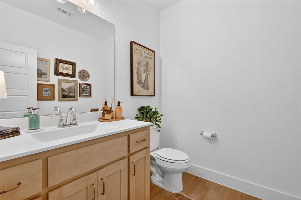 7117 Mantle Ridge Drive Fort Worth, TX 76179 - Photo 27 of 38 a bathroom with a toilet a sink and mirror