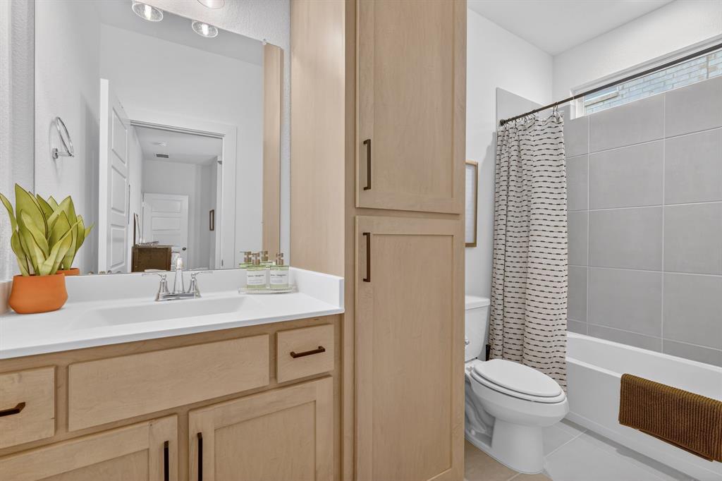 7117 Mantle Ridge Drive Fort Worth, TX 76179 - Photo 28 of 38 a bathroom with a sink toilet and shower