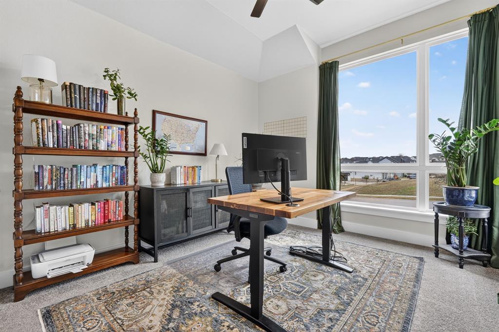 7117 Mantle Ridge Drive Fort Worth, TX 76179 - Photo 29 of 38 a view of a workspace with furniture and a book shelf