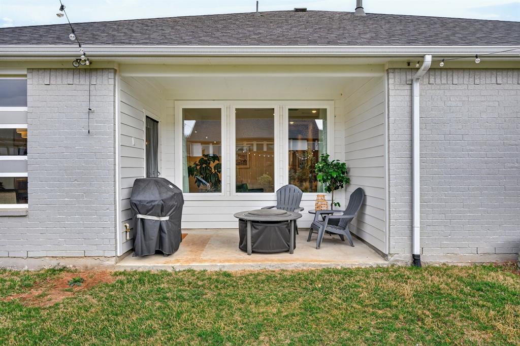 7117 Mantle Ridge Drive Fort Worth, TX 76179 - Photo 35 of 38 a view of a patio with table and chairs potted plants and floor to ceiling window