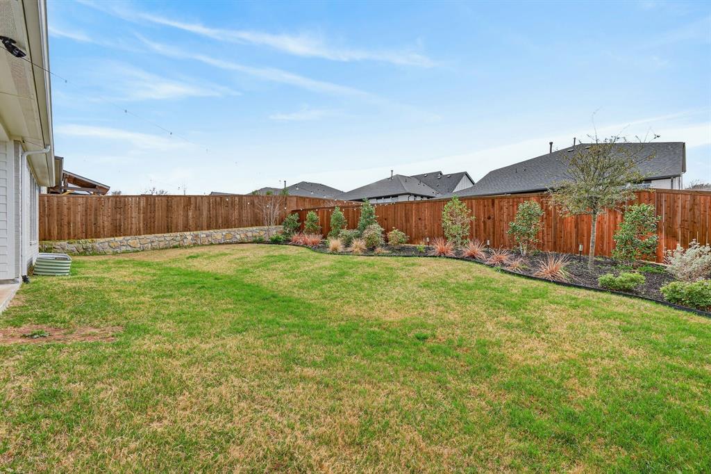 7117 Mantle Ridge Drive Fort Worth, TX 76179 - Photo 36 of 38 a view of yard with large tree and wooden fence