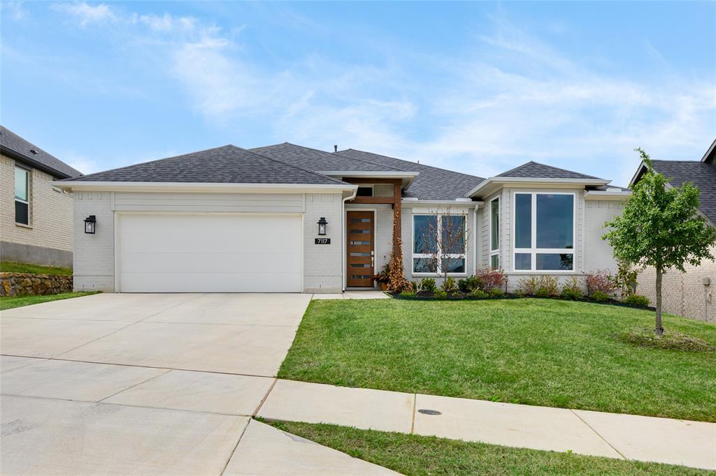 7117 Mantle Ridge Drive Fort Worth, TX 76179 - Photo 4 of 38 a front view of a house with a garden