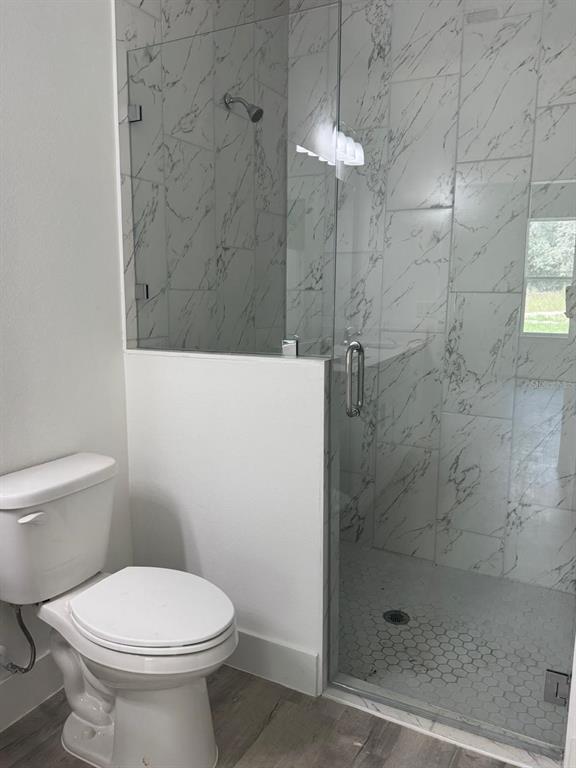 9187 North Travis Drive, Unit 9189 Citrus Springs, FL 34434 - Photo 17 of 21 a bathroom with a toilet and a shower