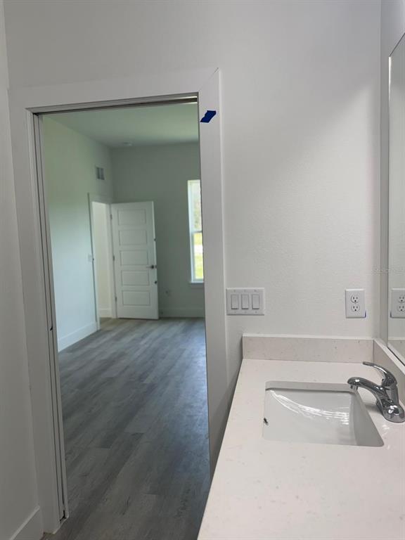 9187 North Travis Drive, Unit 9189 Citrus Springs, FL 34434 - Photo 19 of 21 wooden floor with a sink